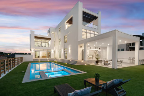 green grass field near body of water during daytime
